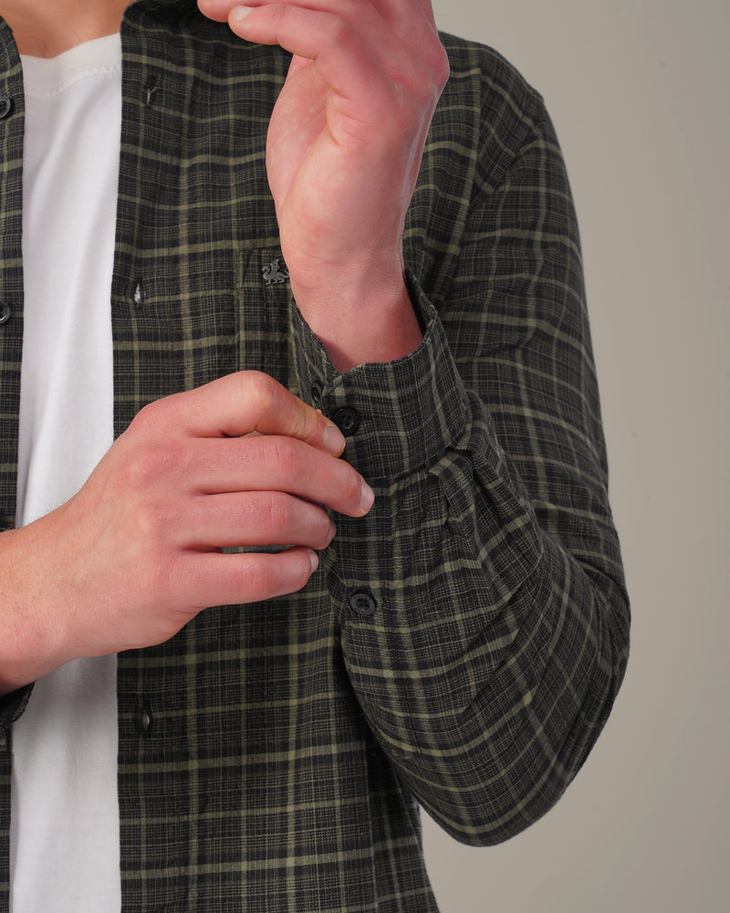 Full-length view of The Olive Check Shirt worn open with chinos